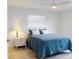 Charming bedroom with light hardwood floors, a plush bed, and bright, airy windows at 1818 Enterprise Ave # B, New Smyrna Beach, FL 32168