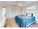 Bedroom with white walls, wood-look flooring, and double closets at 1818 Enterprise Ave # B, New Smyrna Beach, FL 32168