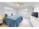 Serene bedroom featuring sleek flooring, soft bedding, and bright natural light at 1818 Enterprise Ave # B, New Smyrna Beach, FL 32168