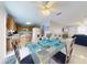 Open-concept dining area connects to kitchen and living room, featuring a glass table and tile floors at 1818 Enterprise Ave # B, New Smyrna Beach, FL 32168