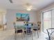 Bright dining room featuring tile flooring, a glass-top table, and a coastal-themed art piece at 1818 Enterprise Ave # B, New Smyrna Beach, FL 32168