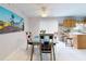 Light-filled dining area featuring a glass-top table and chairs, adjacent to the kitchen at 1818 Enterprise Ave # B, New Smyrna Beach, FL 32168