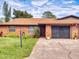 Charming brick home with a well-manicured lawn, cozy curb appeal, and an attached garage, offering comfortable living at 1818 Enterprise Ave # B, New Smyrna Beach, FL 32168