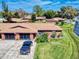 Aerial view of a duplex featuring a well-maintained lawn and brick facade with parking at 1818 Enterprise Ave # B, New Smyrna Beach, FL 32168