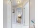 Hallway with neutral paint, tile floor, and white doors leading to bedrooms at 1818 Enterprise Ave # B, New Smyrna Beach, FL 32168