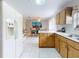 Bright kitchen flows into dining area with modern appliances and tile flooring at 1818 Enterprise Ave # B, New Smyrna Beach, FL 32168