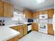 Corner kitchen featuring wood cabinets, white countertops, and stainless steel appliances at 1818 Enterprise Ave # B, New Smyrna Beach, FL 32168