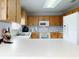 Bright kitchen featuring a white countertop, ample wood cabinetry, and stainless steel appliances at 1818 Enterprise Ave # B, New Smyrna Beach, FL 32168