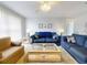 Comfortable living room with sofas, a ceiling fan, and a glass coffee table on a carpet at 1818 Enterprise Ave # B, New Smyrna Beach, FL 32168