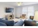 Bright living room with large TV, tile flooring, comfortable seating, and natural light at 1818 Enterprise Ave # B, New Smyrna Beach, FL 32168