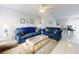 Inviting living area with tile floors, ceiling fan, and nautical-themed decorations at 1818 Enterprise Ave # B, New Smyrna Beach, FL 32168