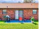 Outdoor patio featuring a grill, seating, and lush lawn with a brick exterior at 1818 Enterprise Ave # B, New Smyrna Beach, FL 32168
