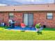 Charming brick patio featuring outdoor seating, a grill, lush lawn, and a cozy setting at 1818 Enterprise Ave # B, New Smyrna Beach, FL 32168