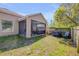 A fenced-in backyard features a screened-in porch, a grill, and a grassy area at 1880 1St Ave, Deland, FL 32724