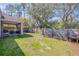 Backyard area with a screened in porch, green lawn, and wooden fence, great for relaxation at 1880 1St Ave, Deland, FL 32724