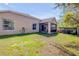 Property's backyard featuring a patio with outdoor furniture, a grill, and a well-maintained lawn at 1880 1St Ave, Deland, FL 32724