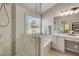 Bright bathroom featuring a tiled shower with glass door, a soaking tub, and a vanity with a makeup area at 1880 1St Ave, Deland, FL 32724