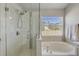 Bathroom featuring a tiled shower with glass door, a soaking tub, and a bright window at 1880 1St Ave, Deland, FL 32724