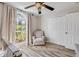 The Bedroom features a rocking chair, a large window, a closet, and wood-look flooring at 1880 1St Ave, Deland, FL 32724