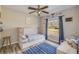 A bedroom features a unique bed design, stylish flooring, a ceiling fan, and a window overlooking the yard at 1880 1St Ave, Deland, FL 32724