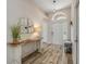 Bright foyer featuring wood-look floors, a console table, and a view of the front door at 1880 1St Ave, Deland, FL 32724
