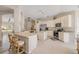 Open kitchen with white cabinets, stainless steel appliances, and a breakfast bar area at 1880 1St Ave, Deland, FL 32724