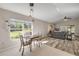 Open-concept living space featuring dining area, hardwood floors, and lots of natural light at 1880 1St Ave, Deland, FL 32724