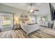 Spacious main bedroom featuring hardwood floors, ceiling fan and plenty of natural light at 1880 1St Ave, Deland, FL 32724