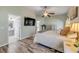 A spacious main bedroom featuring stylish wood flooring, a ceiling fan, and an ensuite bathroom at 1880 1St Ave, Deland, FL 32724