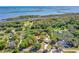 Aerial view of the property with lush surroundings and proximity to the water, showcasing an idyllic coastal setting at 191 Howes St, Oak Hill, FL 32759
