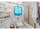 Bright full bathroom with updated fixtures including vanity and shower/tub combo with shower door at 191 Howes St, Oak Hill, FL 32759
