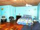 Bedroom with colorful bedspread, light blue walls, and wooden floors at 191 Howes St, Oak Hill, FL 32759