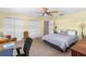 Bedroom with carpet, two closets, and ceiling fan at 191 Howes St, Oak Hill, FL 32759
