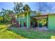 House has two levels, a carport, stairs to the upper level and is surrounded by lush landscaping at 191 Howes St, Oak Hill, FL 32759
