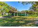 Charming home featuring a covered front porch and lush landscaping at 191 Howes St, Oak Hill, FL 32759