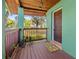 Inviting front porch featuring a wooden deck, colorful welcome mat, and decorative plants at 191 Howes St, Oak Hill, FL 32759