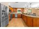 Spacious kitchen featuring stainless steel appliances, custom wood cabinetry, and granite countertops at 191 Howes St, Oak Hill, FL 32759