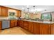 Well-appointed kitchen featuring wood cabinets, tile floors, and granite countertops at 191 Howes St, Oak Hill, FL 32759