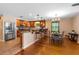 An open-concept kitchen with stainless steel appliances, granite countertops, and bar stool seating at 191 Howes St, Oak Hill, FL 32759