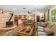 Open concept living area with wood floors, a fireplace, and a view of the kitchen at 191 Howes St, Oak Hill, FL 32759