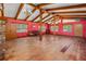 Spacious living room with red walls, wood floors, and exposed beams at 191 Howes St, Oak Hill, FL 32759
