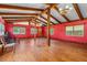 Spacious living room with wooden floors, exposed beams, and plenty of natural light at 191 Howes St, Oak Hill, FL 32759