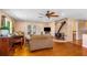 Comfortable living room featuring hardwood floors, a ceiling fan, and a fireplace at 191 Howes St, Oak Hill, FL 32759