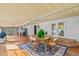 Covered patio with a wooden table and chairs, and a blue patterned rug at 191 Howes St, Oak Hill, FL 32759