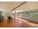 Enclosed porch with many windows and chairs at 191 Howes St, Oak Hill, FL 32759