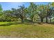 Picturesque property featuring mature trees, lush lawn, and multiple residences at 191 Howes St, Oak Hill, FL 32759