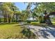Sprawling property featuring mature trees, lush lawns and a long driveway leading to multiple residences at 191 Howes St, Oak Hill, FL 32759