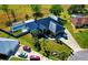Stunning aerial view of home featuring lush landscaping, a spacious driveway, and screened in pool at 1948 Spruce Creek Lndg, Port Orange, FL 32128