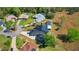 Aerial view of the home with a metal roof and solar panels, as well as a screened-in pool at 1948 Spruce Creek Lndg, Port Orange, FL 32128