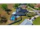 Expansive aerial showcases a home with a metal roof, solar panels, screened pool, and spacious lot at 1948 Spruce Creek Lndg, Port Orange, FL 32128